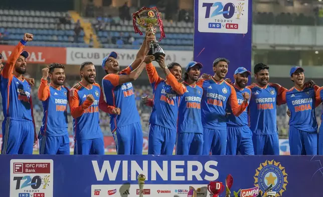 Indian players celebrate with the trophy after winning the T20 cricket series against England at Wankhede Stadium in Mumbai, India, Sunday, Feb. 2, 2025.(AP Photo/Rafiq Maqbool)