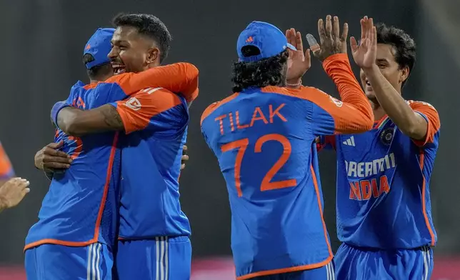 India's players celebrates the wicket of England's Jamie Overton during the fifth Twenty20 cricket match between India and England at Wankhede Stadium in Mumbai, India, Sunday, Feb. 2, 2025.(AP Photo/Rafiq Maqbool)