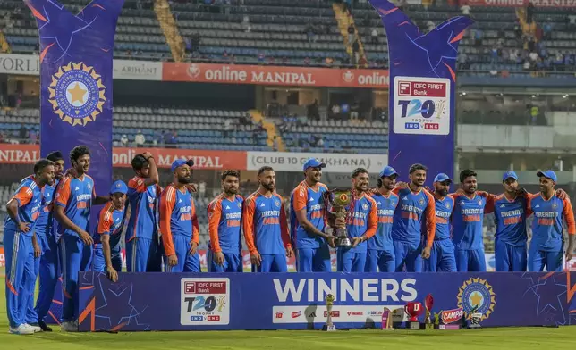 Indian players celebrate with the trophy after winning the T20 cricket series against England at Wankhede Stadium in Mumbai, India, Sunday, Feb. 2, 2025.(AP Photo/Rafiq Maqbool)