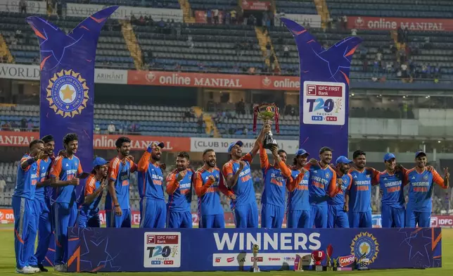 Indian players celebrate with the trophy after winning the T20 cricket series against England at Wankhede Stadium in Mumbai, India, Sunday, Feb. 2, 2025.(AP Photo/Rafiq Maqbool)