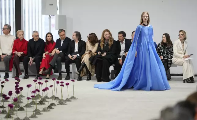 Carolina Herrera, second from left, looks on as a model walks the runway during the Carolina Herrera Fall/Winter 2025 fashion show as part of New York Fashion Week on Monday, Feb. 10, 2025, in New York. (Photo by Charles Sykes/Invision/AP)