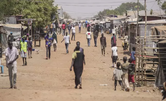 IDP (Internally Displaced Person) walk along a street in Juba, South Sudan Thursday, Feb. 13, 2025. (AP Photo/Brian Inganga)