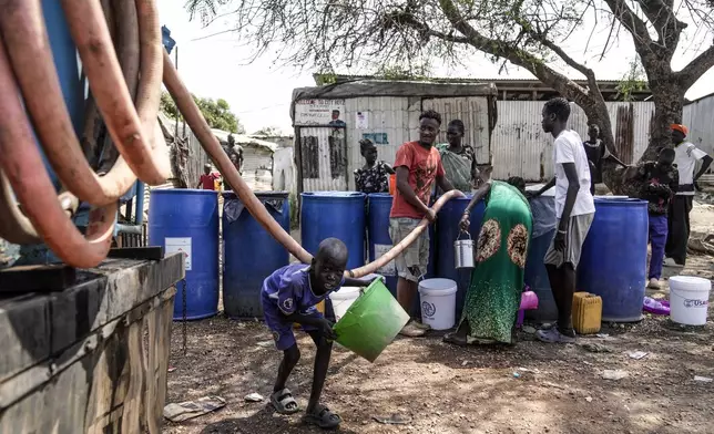 Internally displaced persons (IDP) fetch water inside a camp in Juba, South Sudan Wednesday, Feb. 12, 2025. (AP Photo/Brian Inganga)