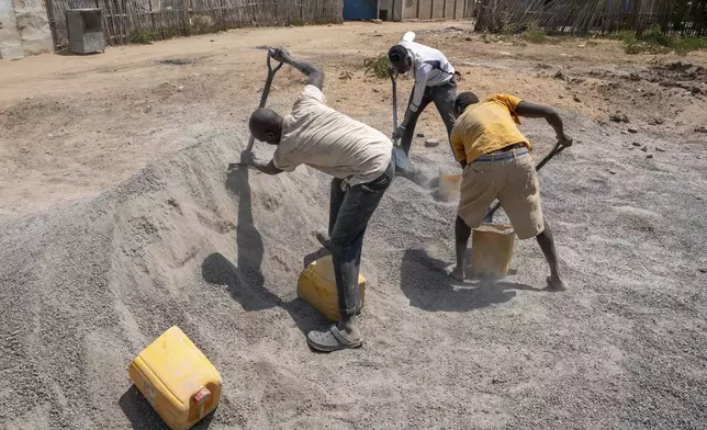 People work at a cement blocks production workshop in Juba, South Sudan Friday, Feb. 21, 2025. (AP Photo/Florence Miettaux)