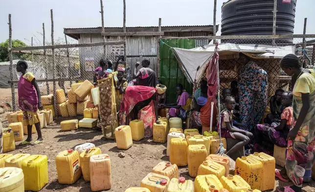 IDP (Internally Displaced Person) fetch water inside a camp in the outskirts of Juba, South Sudan Thursday, Feb. 13, 2025. (AP Photo/Brian Inganga)