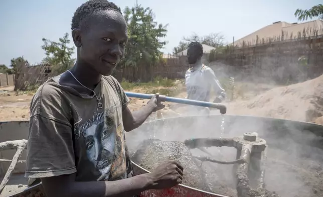 Workers at a cement blocks production workshop in the Rock City area in Juba, South Sudan Friday, Feb. 21, 2025. (AP Photo/Florence Miettaux)