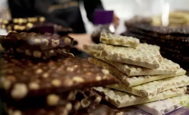 Chocolate bark is on display behind a glass counter at The Chocolate Line in Bruges, Belgium, Thursday, Feb. 6, 2025. (AP Photo/Virginia Mayo)