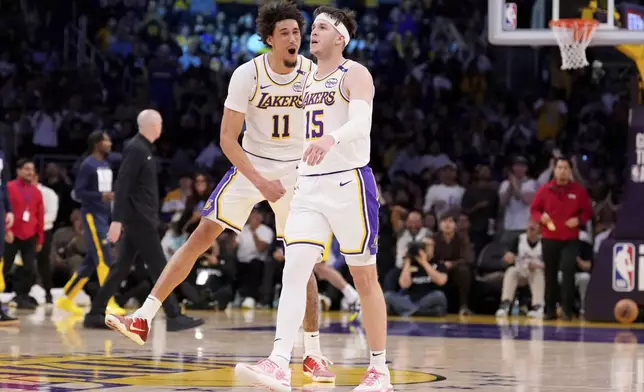 Los Angeles Lakers guard Austin Reaves, right, celebrates with center Jaxson Hayes after scoring during the second half of an NBA basketball game against the Indiana Pacers, Saturday, Feb. 8, 2025, in Los Angeles. (AP Photo/Mark J. Terrill)