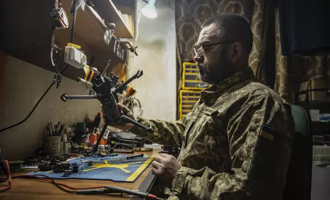 A Ukrainian soldier repairs a FPV drone in a drone repair workshop close to the front line near Siversk, Donetsk region, Ukraine, Thursday, Feb. 6, 2025. (AP Photo/Roman Chop)