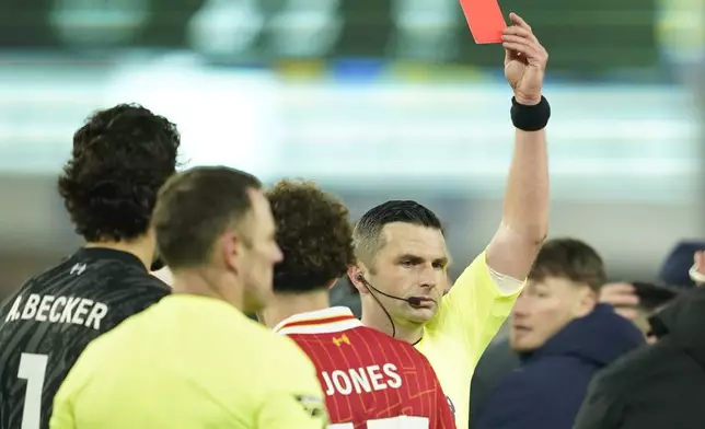 Referee Michael Oliver shows a red card to Liverpool's Curtis Jones during the English Premier League soccer match between Everton and Liverpool, Liverpool, England, Wednesday, Feb.12, 2025. (AP Photo/Dave Thompson)
