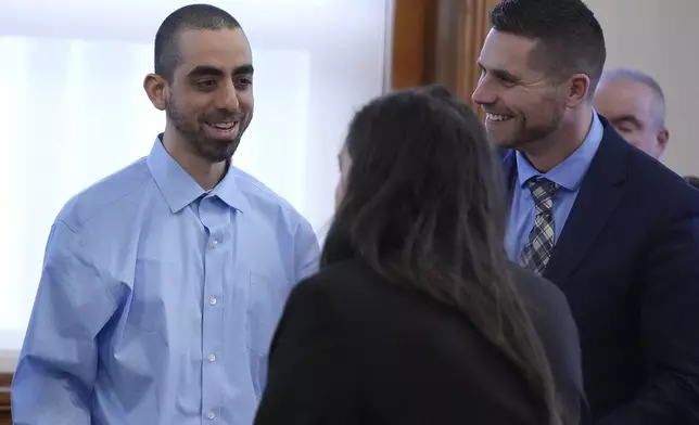 Hadi Matar, left, talks with his defense team before leaving the courtroom at the Chautauqua County courthouse after his second day of trial, Tuesday, Feb. 11, 2025, in Mayville, N.Y. Matar is charged with stabbing famed author Salman Rushdie. (AP Photo/Gene J. Puskar)