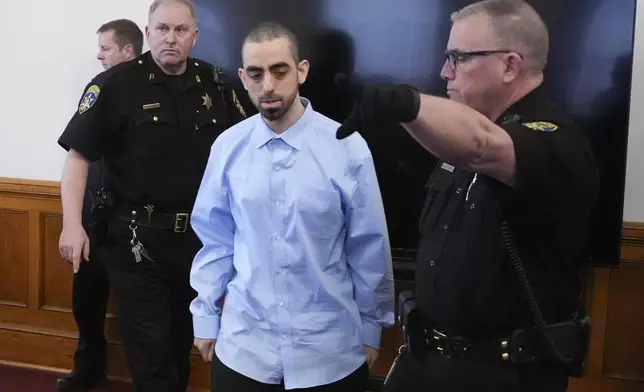 Hadi Matar, center, is escorted into the courtroom at the Chautauqua County Courthouse ahead of the second day in his trial, Tuesday, Feb. 11, 2025, in Mayville, N.Y. Matar is charged with stabbing famed author Salman Rushdie. (AP Photo/Gene J. Puskar)