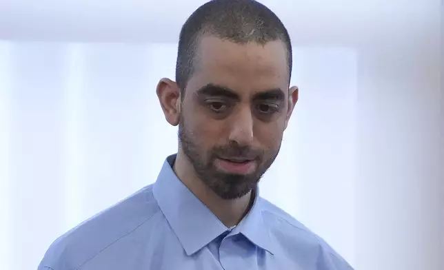 Hadi Matar talks with his defense team before leaving the courtroom at the Chautauqua County courthouse after his second day of trial, Tuesday, Feb. 11, 2025, in Mayville, N.Y. Matar is charged with stabbing famed author Salman Rushdie. (AP Photo/Gene J. Puskar)