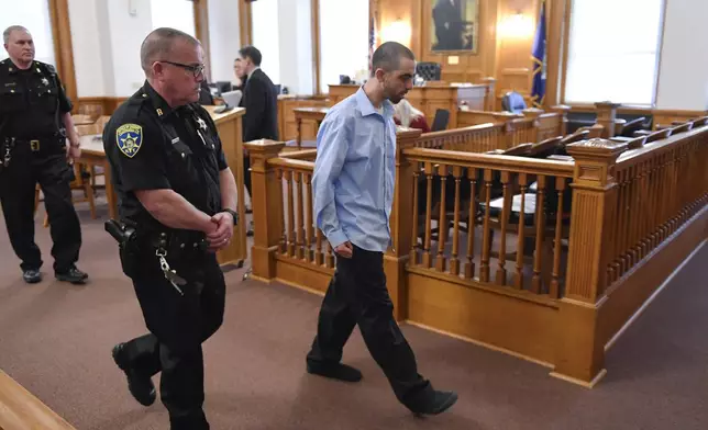 Hadi Matar, center, charged with severely injuring author Salman Rushdie in a 2022 knife attack, is led out of Chautauqua County court in Mayville, N.Y., Monday, Feb. 10, 2025. (AP Photo/Adrian Kraus)
