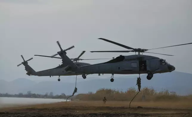 Special forces from Spain land on a beach from a military helicopter as they participate in the Steadfast Dart 2025 exercise, involving some 10,000 troops in three different countries from nine nations and represent the largest NATO operation planned this year, in Nea Anchialos, central Greece, Thursday, Feb. 13, 2025. (AP Photo/Thanassis Stavrakis)