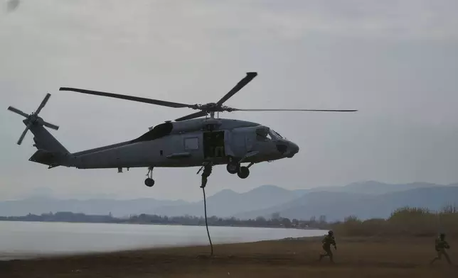 Special forces from Spain land on a beach from a military helicopter as they participate in the Steadfast Dart 2025 exercise, involving some 10,000 troops in three different countries from nine nations and represent the largest NATO operation planned this year, in Nea Anchialos, central Greece, Thursday, Feb. 13, 2025. (AP Photo/Thanassis Stavrakis)