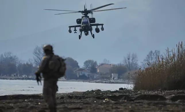 An Apache helicopter of Greek Air Force participate in the Steadfast Dart 2025 exercise, involving some 10,000 troops in three different countries from nine nations and represent the largest NATO operation planned this year, in Nea Anchialos, central Greece, Thursday, Feb. 13, 2025. (AP Photo/Thanassis Stavrakis)