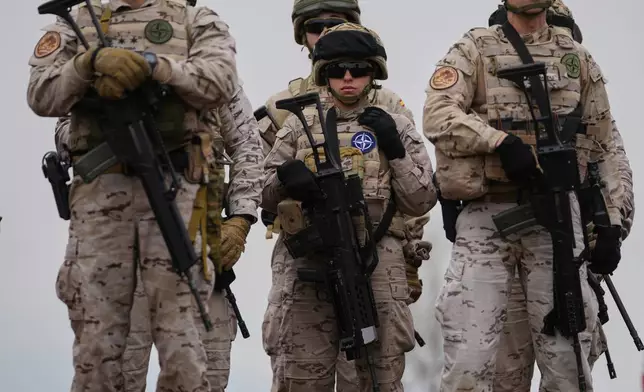 Special forces from Spain stand after the end of the second day of the Steadfast Dart 2025 exercise, involving some 10,000 troops in three different countries from nine nations and represent the largest NATO operation planned this year, in Nea Anchialos, central Greece, Thursday, Feb. 13, 2025. (AP Photo/Thanassis Stavrakis)