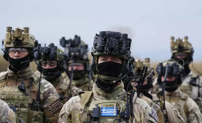 Special forces from Greece stand after the end of the second day of the Steadfast Dart 2025 exercise, involving some 10,000 troops in three different countries from nine nations and represent the largest NATO operation planned this year, in Nea Anchialos, central Greece, Thursday, Feb. 13, 2025. (AP Photo/Thanassis Stavrakis)