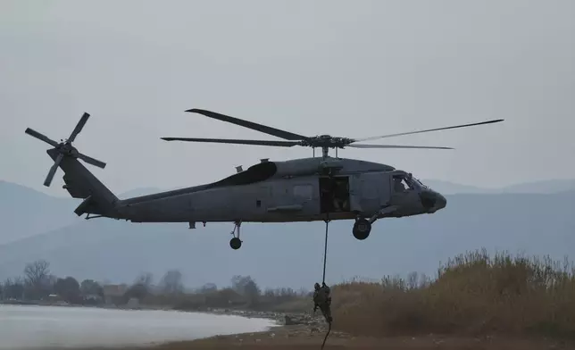 Special forces from Spain land on a beach from a military helicopter as they participate in the Steadfast Dart 2025 exercise, involving some 10,000 troops in three different countries from nine nations and represent the largest NATO operation planned this year, in Nea Anchialos, central Greece, Thursday, Feb. 13, 2025. (AP Photo/Thanassis Stavrakis)