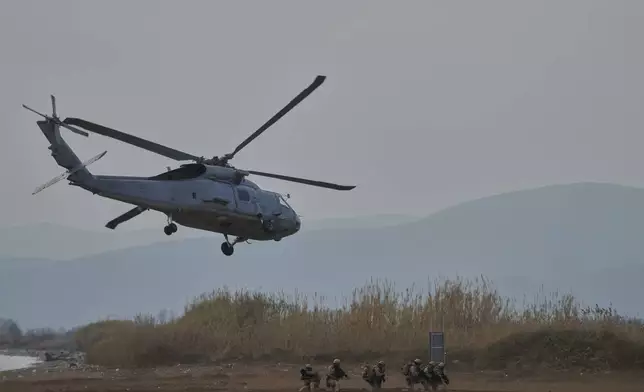Special forces from Spain land on a beach from a military helicopter as they participate in the Steadfast Dart 2025 exercise, involving some 10,000 troops in three different countries from nine nations and represent the largest NATO operation planned this year, in Nea Anchialos, central Greece, Thursday, Feb. 13, 2025. (AP Photo/Thanassis Stavrakis)