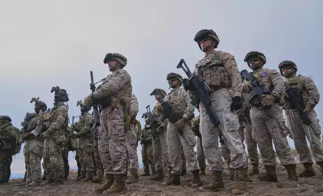 Special forces from Spain stand after the end of the second day of the Steadfast Dart 2025 exercise, involving some 10,000 troops in three different countries from nine nations and represent the largest NATO operation planned this year, in Nea Anchialos, central Greece, Thursday, Feb. 13, 2025. (AP Photo/Thanassis Stavrakis)