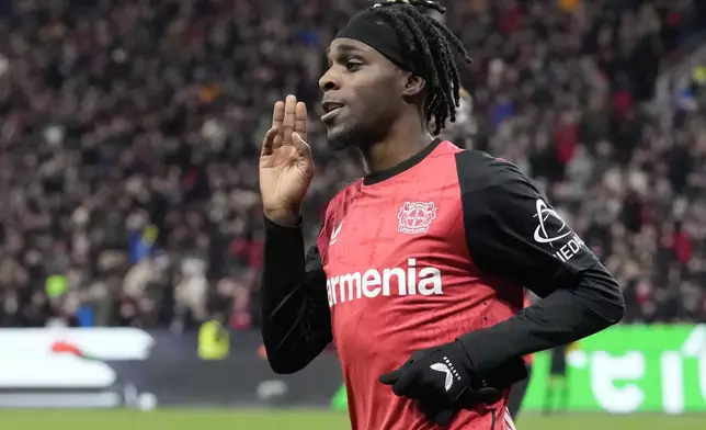 Leverkusen's Jeremie Frimpong celebrates after he scored his side's second goal during the German Bundesliga soccer match between Bayer Leverkusen and TSG Hoffenheim at the BayArena in Leverkusen, Germany, Sunday, Feb. 2, 2025. (AP Photo/Martin Meissner)