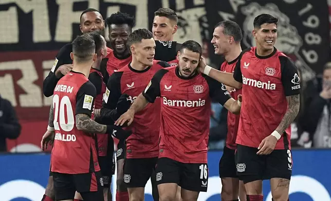 Leverkusen's Patrik Schick is celebrated by his team after scoring his side's third goal during the German Bundesliga soccer match between Bayer Leverkusen and TSG Hoffenheim at the BayArena in Leverkusen, Germany, Sunday, Feb. 2, 2025. (AP Photo/Martin Meissner)