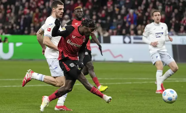 Leverkusen's Jeremie Frimpong scores his side's second goal during the German Bundesliga soccer match between Bayer Leverkusen and TSG Hoffenheim at the BayArena in Leverkusen, Germany, Sunday, Feb. 2, 2025. (AP Photo/Martin Meissner)