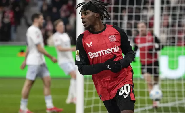 Leverkusen's Jeremie Frimpong celebrates after he scored his side's second goal during the German Bundesliga soccer match between Bayer Leverkusen and TSG Hoffenheim at the BayArena in Leverkusen, Germany, Sunday, Feb. 2, 2025. (AP Photo/Martin Meissner)