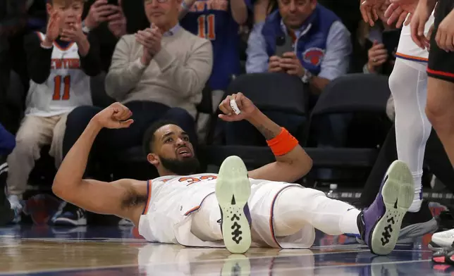 New York Knicks center Karl-Anthony Towns flexes after making a basket against the Atlanta Hawks during the second half of an NBA basketball game Wednesday, Feb. 12, 2025, in New York. (AP Photo/John Munson)