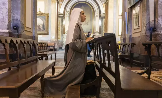 Missionary nun Maria Engracia, from Mexico, prays for the health of Pope Francis at the Metropolitan Cathedral in Buenos Aires, Buenos Aires, Argentina, Friday, Feb. 21, 2025. (AP Photo/Rodrigo Abd)