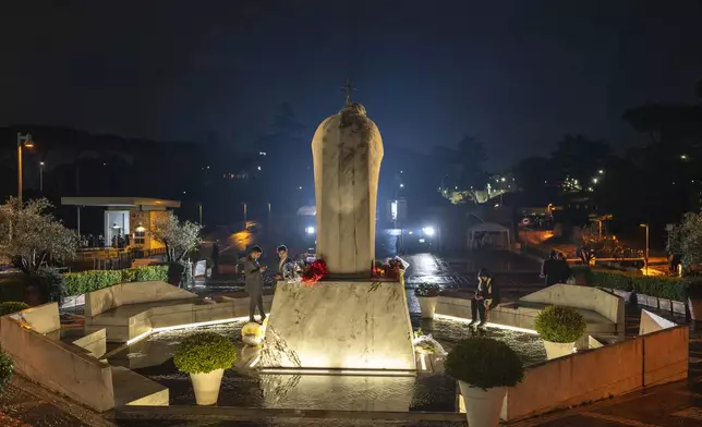 Faithful pray outside the Agostino Gemelli Polyclinic, in Rome, Tuesday, Feb. 25, 2025 where Pope Francis is hospitalized since Friday, Feb. 14. (AP Photo/Mosa'ab Elshamy)