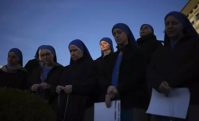 Nuns pray for Pope Francis in front of the Agostino Gemelli Polyclinic, in Rome, Saturday, Feb. 22, 2025, where the Pontiff is hospitalized since Friday, Feb. 14.(AP Photo/Alessandra Tarantino)
