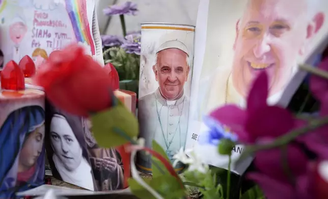 Candles and photos for Pope Francis are seen at the Agostino Gemelli Polyclinic, in Rome, Monday, Feb. 24, 2025 where the Pontiff is hospitalized since Friday, Feb. 14. (AP Photo/Alessandra Tarantino)