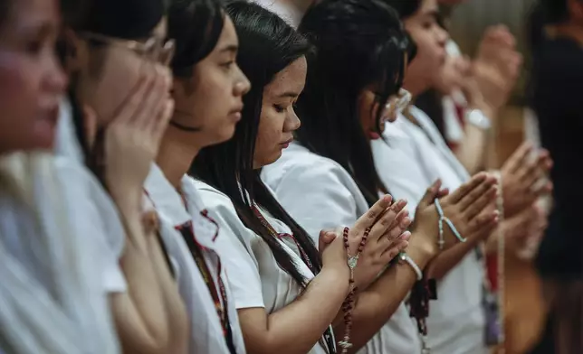 Catholic faithful gather at the Immaculate Conception Cathedral popularly known as the Manila Cathedral in Manila, Philippines on Friday Feb. 21, 2025 to pray for the healing and recovery of Pope Francis as part of a nationwide call for prayers initiated by the Catholic Bishop's Conference of the Philippines. (AP Photo/Gerard Carreon)