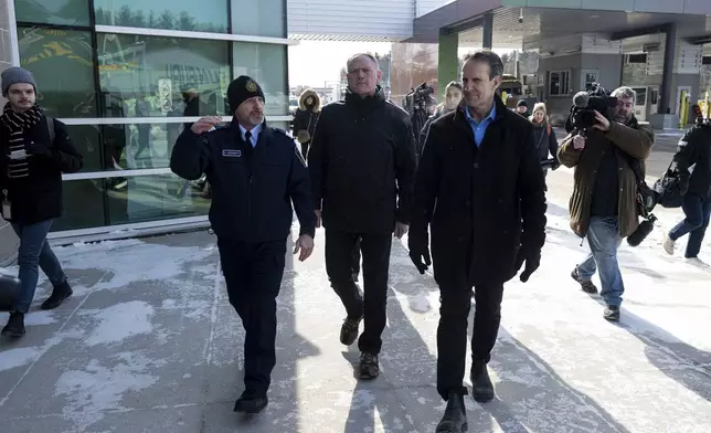 Minister of Public Safety David McGuinty, center, and Canada's Fentanyl Czar Kevin Brosseau, right, are seen during a tour of the Canada Border Services Agency (CBSA) Lansdowne Port of Entry in Lansdowne, Ontario, on Wednesday, Feb. 12, 2025. (Spencer Colby/The Canadian Press via AP)