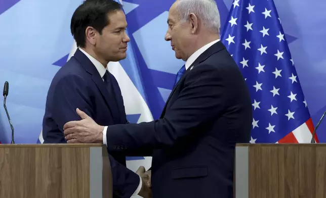 U.S. Secretary of State Marco Rubio, left, and Israeli Prime Minister Benjamin Netanyahu shake hands during a news conference at the Prime Minister's office in Jerusalem, Israel, Sunday, Feb. 16, 2025. (Evelyn Hockstein/Pool Photo via AP)