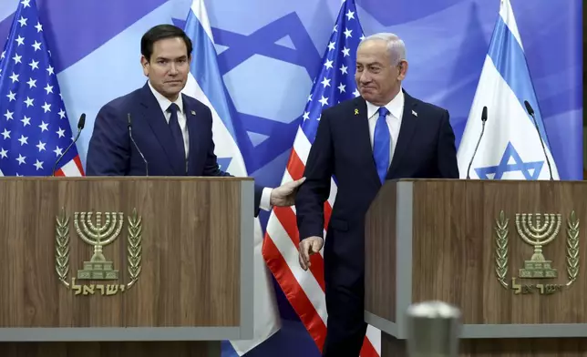 U.S. Secretary of State Marco Rubio, left, and Israeli Prime Minister Benjamin Netanyahu shake hands during a news conference at the Prime Minister's office in Jerusalem, Israel, Sunday, Feb. 16, 2025. (Evelyn Hockstein/Pool Photo via AP)
