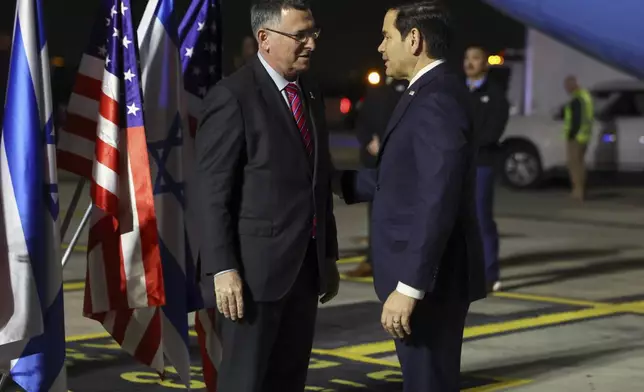 Israel's Foreign Minister Gideon Sa'ar welcomes U.S. Secretary of State Marco Rubio as he arrives in Israel, on the first leg of his Middle East trip, in Tel Aviv, Israel, on Saturday, Feb. 15, 2025. (Evelyn Hockstein/Pool Photo via AP)
