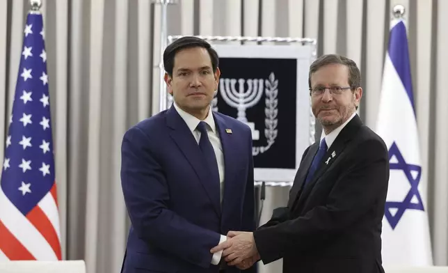 U.S. Secretary of State Marco Rubio, left, shakes hands with Israeli President Isaac Herzog during their meeting in Jerusalem, Israel, Sunday Feb. 16, 2025. (Abir Sultan/Pool Photo via AP)