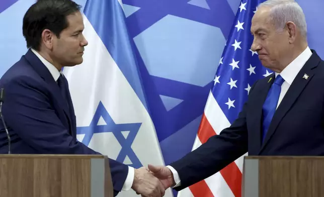 U.S. Secretary of State Marco Rubio, left, and Israeli Prime Minister Benjamin Netanyahu shake hands during a news conference at the Prime Minister's office in Jerusalem, Israel, Sunday, Feb. 16, 2025. (Evelyn Hockstein/Pool Photo via AP)