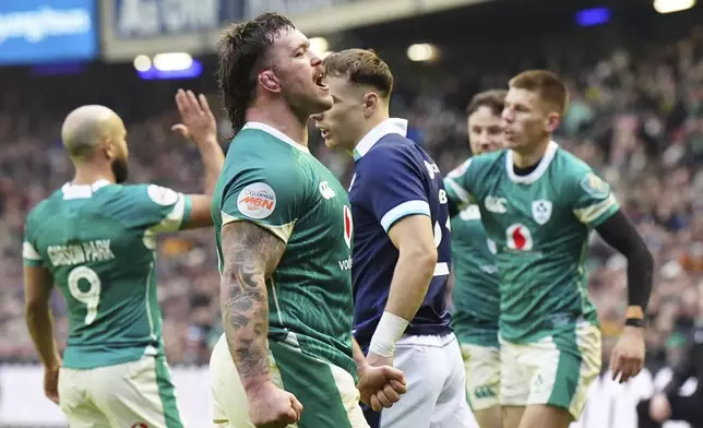 Ireland's Caelan Doris celebrates after scoring a try during the Six Nations match between Scotland and Ireland at Murrayfield Stadium, Edinburgh, Sunday Feb. 9, 2025. (Jane Barlow/PA via AP)