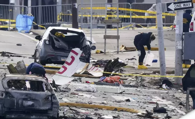 FILE - Investigators work the scene after a small plane crashed in Philadelphia, Feb. 1, 2025. (AP Photo/Matt Rourke, File)