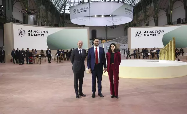 United States Vice-President JD Vance, center, is welcomed by French Foreign Minister Jean-Noel Barrot, left, and French businesswoman Clara Chappaz at the Grand Palais during the Artificial Intelligence Action Summit in Paris, Tuesday, Feb. 11, 2025. (AP Photo/Thomas Padilla)