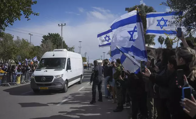 The convoy carrying the coffins of four Israeli hostages, including a mother and her two children, arrives at the Abu Kabir Forensic Institute in Tel Aviv, Israel, Thursday Feb. 20, 2025 after they were handed over by Palestinian militant groups in Gaza.(AP Photo/Ohad Zwigenberg)