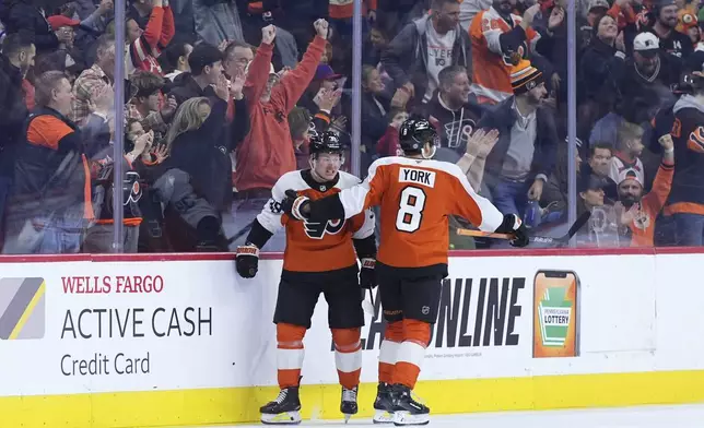 Philadelphia Flyers' Matvei Michkov, left, and Cam York celebrate after a goal by Michkov during the first period of an NHL hockey game against the Edmonton Oilers, Saturday, Feb. 22, 2025, in Philadelphia. (AP Photo/Matt Slocum)