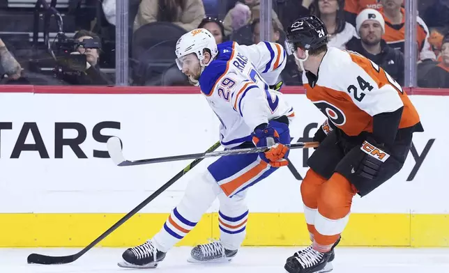 Edmonton Oilers' Leon Draisaitl, left, tries to get past Philadelphia Flyers' Nick Seeler during the first period of an NHL hockey game, Saturday, Feb. 22, 2025, in Philadelphia. (AP Photo/Matt Slocum)