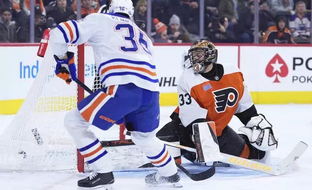 Philadelphia Flyers' Samuel Ersson, right, cannot stop a goal by Edmonton Oilers' John Klingberg during the first period of an NHL hockey game, Saturday, Feb. 22, 2025, in Philadelphia. (AP Photo/Matt Slocum)
