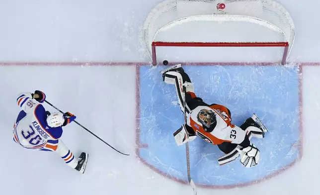 Edmonton Oilers' John Klingberg, left, scores a goal against Philadelphia Flyers' Samuel Ersson during the first period of an NHL hockey game, Saturday, Feb. 22, 2025, in Philadelphia. (AP Photo/Matt Slocum)